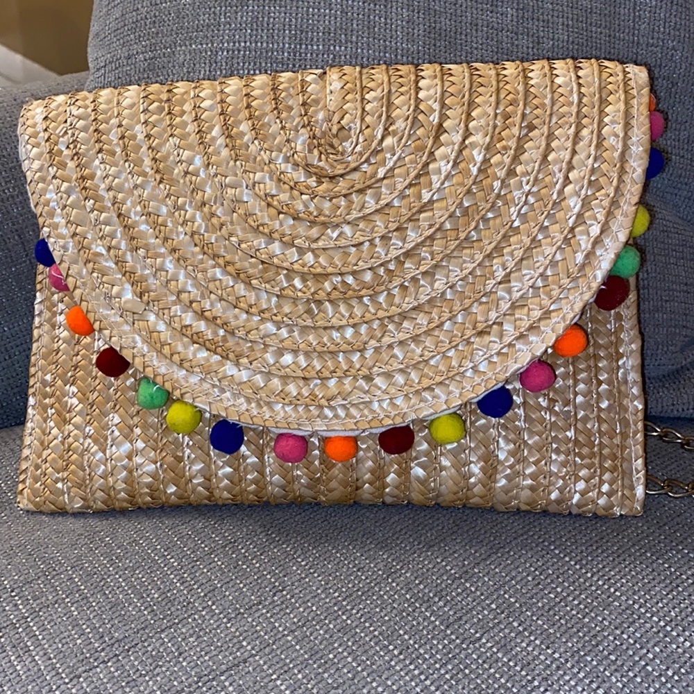 Wicker envelope shoulder bag with pom poms and chain measures 8x12 inches